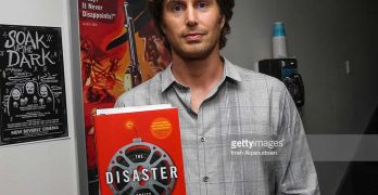 Greg Sestero posing with The Disaster Artist, the Book