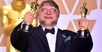 Guillermo Del Toro with his two Oscar statuettes for Best Picture and Directing