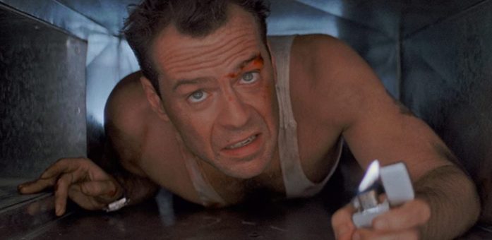 Bruce Willis in Die Hard (1988) - no spoiler in logline.